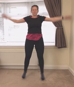 Photo of Norma Thallon performing jumping jacks