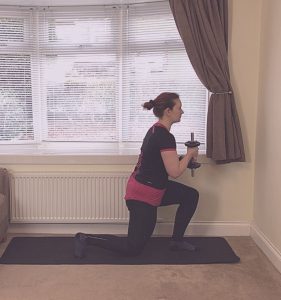 Photo of Norma Thallon doing weighted lunges